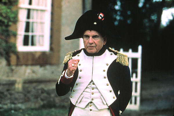 Image of Napoleon with a fist in hand, looking outwards as if he has conjured an excellence thought. EMPEROR'S NEW CLOTHES, Ian Holm, 2002 (c) Paramount. Courtesy Everett Collection.©  Everett Collection / Bridgeman Images